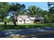Inviting residence with a well-kept lawn, accented by mature trees and a durable metal roof at 5225 Kings Hwy, Douglasville, GA 30135