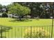 Front yard with a wrought iron railing, a large tree, and a glimpse of the houses across the street at 5225 Kings Hwy, Douglasville, GA 30135
