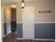 Inviting hallway featuring blue and tan walls, with a charming light fixture and practical coat rack at 5225 Kings Hwy, Douglasville, GA 30135