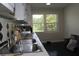 Bright kitchen featuring a stainless steel sink, tiled countertops, and a large window at 5225 Kings Hwy, Douglasville, GA 30135