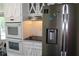 Modern kitchen boasts stainless steel appliances and white cabinets, combining style and functionality at 5225 Kings Hwy, Douglasville, GA 30135