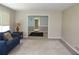 Cozy living room featuring a blue sofa and neutral decor, creating a welcoming atmosphere at 5225 Kings Hwy, Douglasville, GA 30135