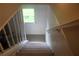 Carpeted stairway with a window at the end provides natural light to the upper level at 5225 Kings Hwy, Douglasville, GA 30135