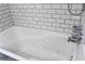 Inviting soaking tub with chrome fixtures and white subway tile surround at 5225 Kings Hwy, Douglasville, GA 30135