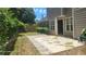 Backyard patio with landscaping and lush greenery, adjacent to the home's exterior at 3219 Roundfield Cir, Duluth, GA 30096