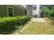 A lush backyard featuring a stone patio, green grass, and well-maintained landscaping at 3219 Roundfield Cir, Duluth, GA 30096