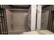 Bathroom with a bathtub, toilet and shelving unit with a large mirror at 3219 Roundfield Cir, Duluth, GA 30096