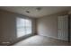 A simple, carpeted bedroom with a window for natural light and a standard door at 3219 Roundfield Cir, Duluth, GA 30096
