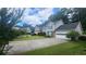 Suburban home with gray siding, green shutters, and a long driveway leading to a two-car garage at 3219 Roundfield Cir, Duluth, GA 30096