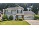 Charming two-story home featuring gray siding, green shutters and a well-maintained lawn at 3219 Roundfield Cir, Duluth, GA 30096