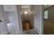 Hallway with stairs leading to a lower level, with carpeted floors and neutral walls at 3219 Roundfield Cir, Duluth, GA 30096