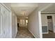 Hallway leading into living room featuring neutral-toned walls and hardwood flooring at 3219 Roundfield Cir, Duluth, GA 30096