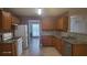 Spacious kitchen features granite counters, white appliances, and wooden cabinetry at 3219 Roundfield Cir, Duluth, GA 30096