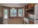 Kitchen view featuring wooden cabinets, granite countertops, a range, and bright windows at 3219 Roundfield Cir, Duluth, GA 30096
