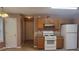Kitchen with wooden cabinets, granite countertops, and white appliances at 3219 Roundfield Cir, Duluth, GA 30096