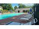 Community pool with multiple lounge chairs and covered picnic area for residents to enjoy on sunny days at 3219 Roundfield Cir, Duluth, GA 30096