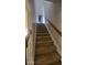 Carpeted staircase leading to the upper level of the home with wood handrail at 3219 Roundfield Cir, Duluth, GA 30096