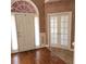 Welcoming foyer featuring hardwood floors, double doors, and an arched transom window at 5035 Harbor Ridge Dr, Buford, GA 30518