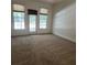 Spacious living room featuring carpet, a door to the outside, and neutral paint at 5035 Harbor Ridge Dr, Buford, GA 30518
