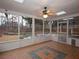 Enclosed sunroom with ceiling fan, tiled floor and a view of the backyard at 5035 Harbor Ridge Dr, Buford, GA 30518