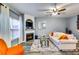 Cozy living room featuring a fireplace, modern decor, comfortable seating, and large windows for ample sunlight at 7750 Carnegie Dr, Fairburn, GA 30213