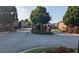 Gated community entrance with brick pillars and a well-maintained landscape island in a quiet neighborhood at 2435 Hickory Station Cir, Snellville, GA 30078
