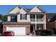 Charming two-story home with brick accents, neutral siding, a two-car garage, and a cozy front porch at 2435 Hickory Station Cir, Snellville, GA 30078
