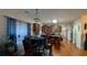 Open kitchen with hardwood floors, brown cabinets, an island, and a breakfast table at 2435 Hickory Station Cir, Snellville, GA 30078
