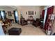 Cozy living room featuring neutral carpet, matching chairs, elegant decor, and abundant natural light at 2435 Hickory Station Cir, Snellville, GA 30078