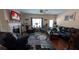 Comfortable living room with a fireplace, a TV, and black leather furniture at 2435 Hickory Station Cir, Snellville, GA 30078