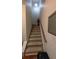 Carpeted staircase with wooden handrail leads to the upper level of the home at 2435 Hickory Station Cir, Snellville, GA 30078
