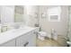Bright bathroom featuring a white vanity, toilet, linen closet, and shower-tub combo at 349 Garnet Dr, Acworth, GA 30101