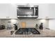 Modern kitchen featuring stainless steel appliances, gas cooktop, and tile backsplash at 349 Garnet Dr, Acworth, GA 30101