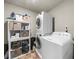 Bright laundry room features washer, dryer, storage shelving, and ample organizational space at 349 Garnet Dr, Acworth, GA 30101