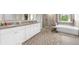 Elegant main bathroom featuring double vanity, walk-in shower, soaking tub, and plenty of storage at 349 Garnet Dr, Acworth, GA 30101
