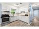 Bright kitchen features white cabinetry, laminate countertops, stainless steel appliances, and a window at 3927 Buck Rd, Powder Springs, GA 30127