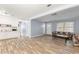 Spacious living room featuring wood-look flooring, open to kitchen and front entry at 3927 Buck Rd, Powder Springs, GA 30127