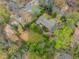Aerial view of a property, featuring a well-maintained yard and mature trees in a quiet neighborhood setting at 2994 Baker Ridge Nw Dr, Atlanta, GA 30318