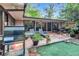 A beautiful outdoor back patio, with a grill, lounging chairs, and table for entertaining Gathering and friends at 2994 Baker Ridge Nw Dr, Atlanta, GA 30318