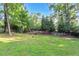 A wide-open backyard, lined with trees, ready for outdoor activities and enjoyment at 2994 Baker Ridge Nw Dr, Atlanta, GA 30318