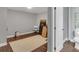 Unfinished basement area with vinyl flooring, neutral walls, and an adjacent half bathroom for convenience at 2994 Baker Ridge Nw Dr, Atlanta, GA 30318