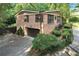 Two-story brick home with a garage and meticulously landscaped yard, providing a serene atmosphere at 2994 Baker Ridge Nw Dr, Atlanta, GA 30318