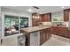Modern kitchen with a granite island, stainless steel appliances and dark cabinets, and a sliding door to the porch at 2994 Baker Ridge Nw Dr, Atlanta, GA 30318