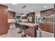 Spacious kitchen with granite countertops, a large island, stainless appliances and dark wood cabinets at 2994 Baker Ridge Nw Dr, Atlanta, GA 30318