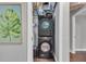 Laundry closet includes a stacked washer and dryer, maximizing space with adjacent storage solutions at 2994 Baker Ridge Nw Dr, Atlanta, GA 30318
