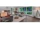 Bright living room with hardwood floors, large windows, and cozy seating arrangement at 2994 Baker Ridge Nw Dr, Atlanta, GA 30318