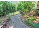 A charming backyard walkway with decorative stone leading through the green landscape at 2994 Baker Ridge Nw Dr, Atlanta, GA 30318