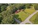 Aerial view of the property showing the house, lush greenery, and quiet neighborhood streets at 6674 Cowan Mill Rd, Winston, GA 30187