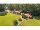 Aerial shot of a home with red roof on a sprawling green lot surrounded by trees at 6674 Cowan Mill Rd, Winston, GA 30187
