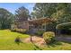 The home boasts an inviting covered porch with a ceiling fan and a peaceful backyard view at 6674 Cowan Mill Rd, Winston, GA 30187